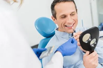 man choosing which color dental veneer he would like