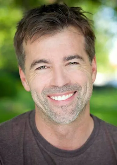 man smiling with his new dental crowns from Pettey Dental of Bartlett