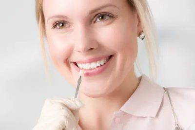 woman picking a color for her new dental veneers