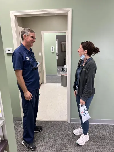 Dr. Pettey discussing dental care with a patient
