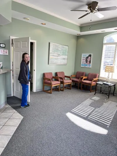 Katie, Pettey Dental of Bartlett's Dental Hygienist, holding the door for a patient